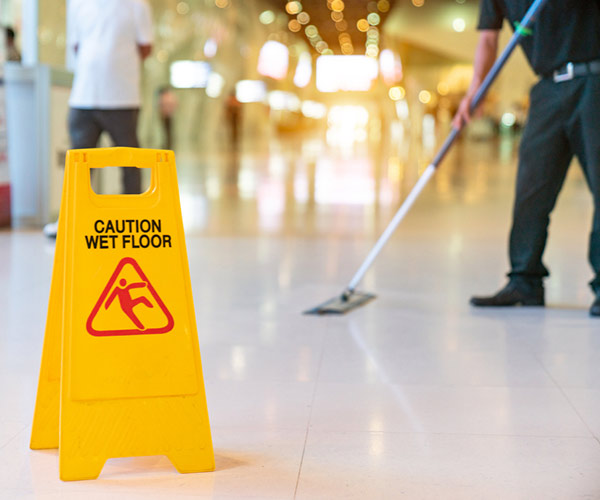 Wet floor sign in lobby to prevent slips and falls in Houston office